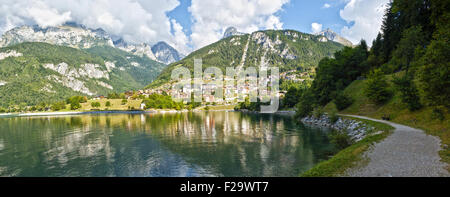 Village of Molveno and lake in a summer cloudy morning with Dolomiti of Brenta group background Stock Photo