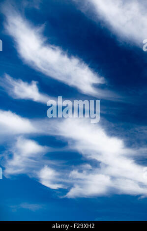 Scenic stratus clouds against deep blue sky Stock Photo