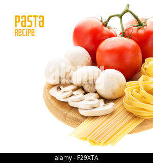 Spaghetti and nest pasta with mushrooms and branch of tomatoes on wooden cutting board with copy space aside Stock Photo