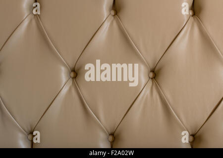 Details of the lining of a leather bed, with buttons, in capitonne style. Stock Photo