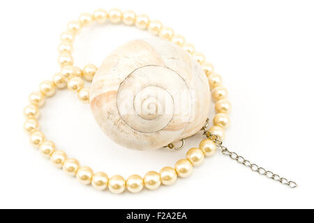 Pearl necklace with spiral seashell isolated on white Stock Photo