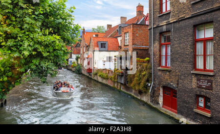 Bruges, Belgium - Aug 18, 2015: Tourists taking boat tour around medieval canals Stock Photo