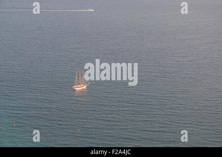 A lone sailboat in the Mediterranean Sea taking in the setting sun. Stock Photo