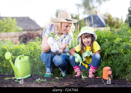 Mother and daughter working in the garden Stock Photo