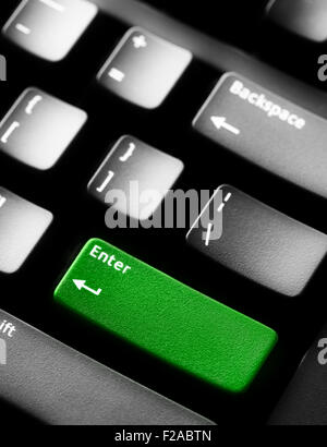 Computer keyboard with green colored enter key Stock Photo
