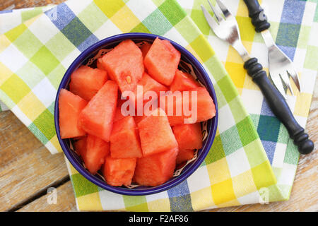 Watermelon cubes in bowl on checkered cloth Stock Photo