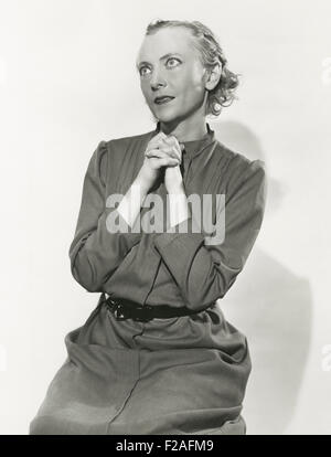Woman on her knees praying (OLVI008 OU389 F) Stock Photo