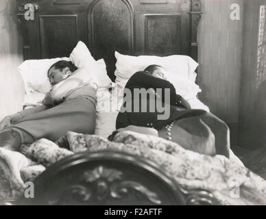 Two men sleeping with their backs to each other (OLVI008 OU314 F) Stock Photo