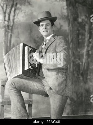 Portrait of young man playing accordion  (OLVI008 OU251 F) Stock Photo