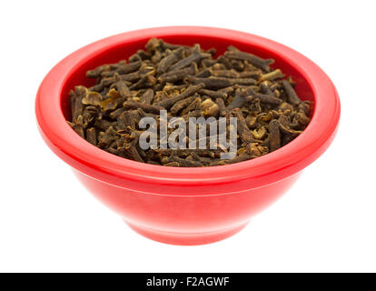 A red dish with a portion of whole cloves isolated on a white background. Stock Photo