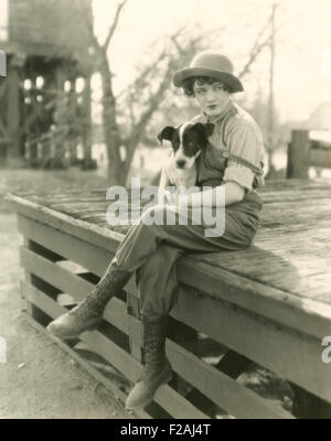 Woman sitting outdoors with her dog (OLVI007 OU840 F) Stock Photo