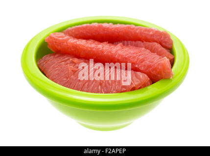 Sections of red grapefruit in a green bowl isolated on a white background Stock Photo