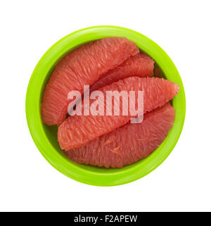 Top view of sections of red grapefruit in a green bowl isolated on a white background. Stock Photo