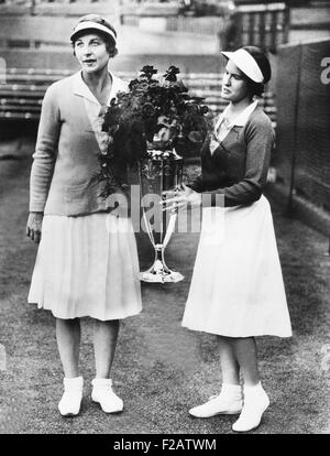 Helen Wills Moody (left) and Sarah Palfrey, with the Wightman Cup. June 20, 1932. The winning doubles partners were presented the trophy by Princess Victoria. America retained Wightman Cup in 1932 by beating the British team by a score of 4 matches to 3. The tennis was played on the courts at Wimbledon, England. (CSU 2015 11 1580) Stock Photo