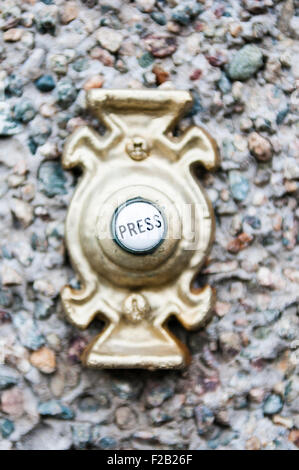 'Press' on the button of a door bell. Stock Photo