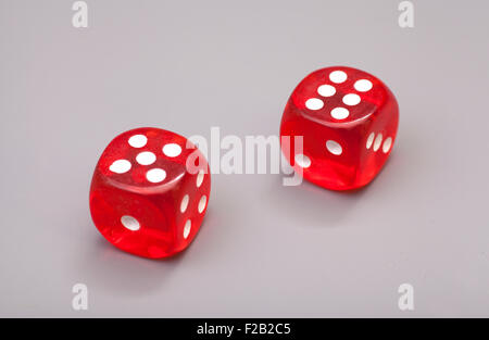 Red dices on grey background Stock Photo