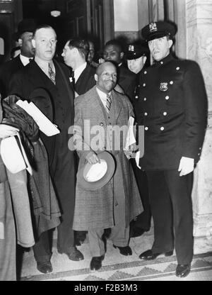 Guarded by a policeman, Father Divine, leaves Felony Court, NYC, April 30, 1937. Divine won a week's postponement of his trial on felonious assault charge, of which he was ultimately cleared. - (CSU 2015 5 71) Stock Photo