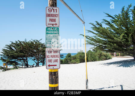Road signs on Telegraph pole next to beach Stock Photo