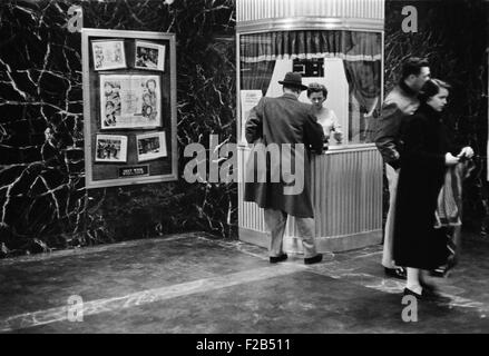 Man purchasing a movie ticket for the film. The coming attraction is the film, ALL MINE TO GIVE. Feb. 9, 1958. - (BSLOC 2015 1 162) Stock Photo