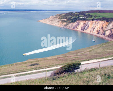 A view of Alum Bay from the cliff leading to The Needles on the most western point of the Isle of Wight. Of geological interest and a tourist attraction, the bay is noted for its multi-coloured sand cliffs. Stock Photo