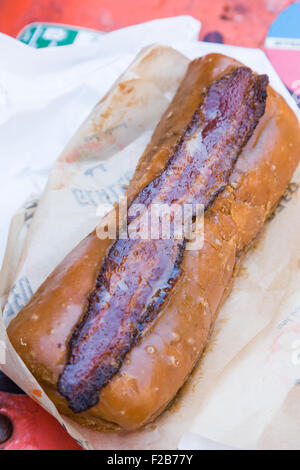 Glazed & Infused Maple Bacon Long John donut in Wicker Park August 2, 2015 in Chicago, Illinois, USA. Stock Photo
