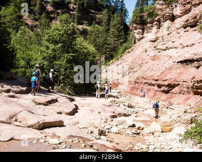 GEOPARC Bletterbach canyon, layers of sediments, stratum, people hike inside the gorge, Aldein, south Tyrolia, Italy Stock Photo