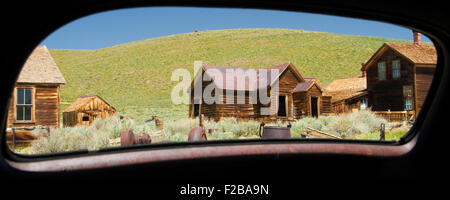 Abandoned buildings viewed through from a mirror of a car, Bodie Ghost Town, Bodie State Historic Park, Mono County, California, Stock Photo