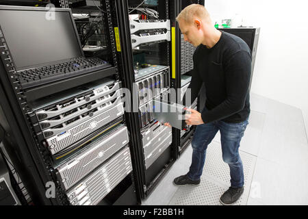IT engineer installs blade server in datacenter Stock Photo