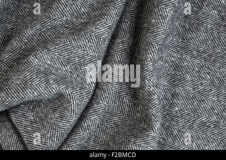 Draped herringbone tweed background with closeup on wool fabric texture Stock Photo