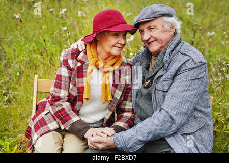 Retired seniors relaxing on green lawn Stock Photo