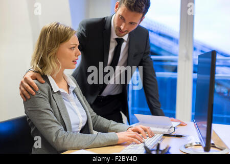 reassuring businessman with stressed colleague in office Stock Photo