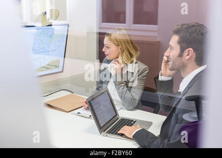 Business colleagues working on laptop in office and meeting Stock Photo