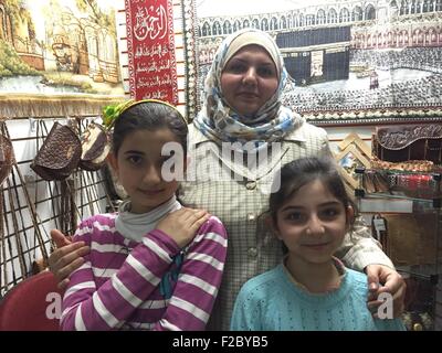 Sao Paulo, Brazil. 15th Sep, 2015. Syrian national Fitoon Assi poses with her daughters Retaj (L) and Rahaf (R) in her small bag store in Sao Paulo, Brazil, 15 September 2015. They arrived here after a long odyssey. Photo: Georg Ismar/dpa/Alamy Live News Stock Photo