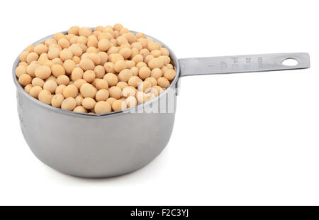 Soybeans, or soya beans, in an American measuring cup, isolated on a white background Stock Photo