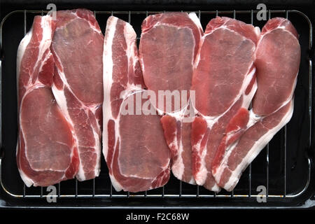 Slices of Bacon laid on top of a grill pan before cooking. Stock Photo