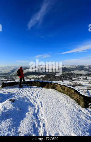 Winter snow, Adult male walker on Baslow Edge, Peak District National Park, Derbyshire, England, UK Stock Photo
