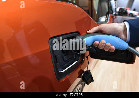 Frankfurt, Germany. 16th Sep, 2015. A recharging cable for electric vehicles is attached to a BMW i3 at the International Motor Show IAA in Frankfurt/Main, 16 September 2015. Around 1,000 exhibitors from 40 countries will present their latest products at the world's leading motor show, which will run from 17 to 27 September 2015. Credit:  dpa picture alliance/Alamy Live News Stock Photo