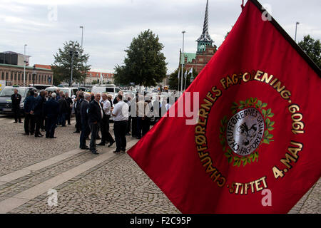 Copenhagen, Denmark. 16th September, 2015. Copenhagen Taxi drivers demonstrate against Uber in front of the Danish Parliament. They claimed that Uber offer their service in violation of the law regarding Taxi driving. Photo, right: Taxi drivers union flag. Credit:  OJPHOTOS/Alamy Live News Stock Photo