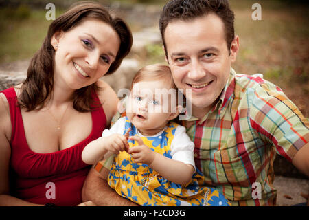 Family portrait - parents and their little cute girl