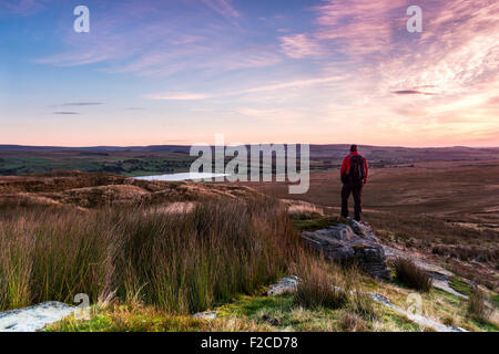 Walker Enjoying the View Over Hury Reservoir and Baldersdale from Goldsborough in Early Morning Light, Teesdale County Durham UK Stock Photo