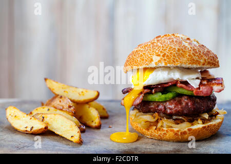 Beef burger with bacon and poached egg Stock Photo