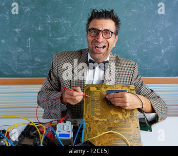 Nerd electronics technician retro teacher silly expression working in pcb Stock Photo