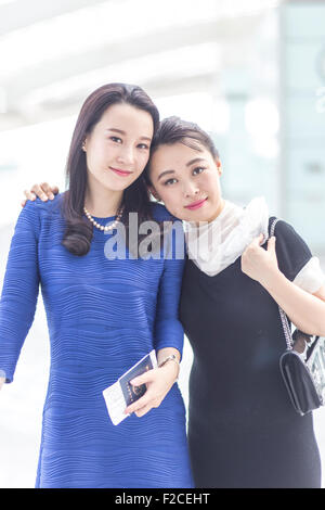 Businesswomen traveling in Beijing International Airport Stock Photo