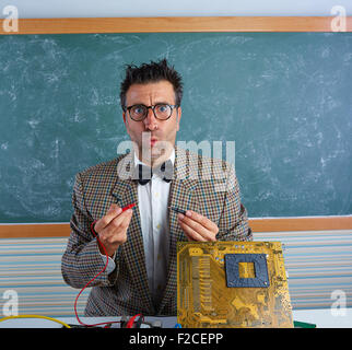 Nerd electronics technician retro teacher silly expression working in pcb Stock Photo
