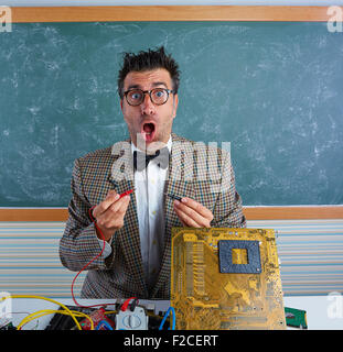 Nerd electronics technician retro teacher silly expression working in pcb Stock Photo