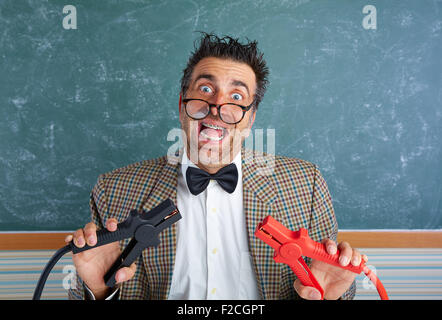 Nerd electronics technician retro teacher silly expression working battery clamps Stock Photo