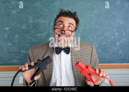 Nerd electronics technician retro teacher silly expression working battery clamps Stock Photo