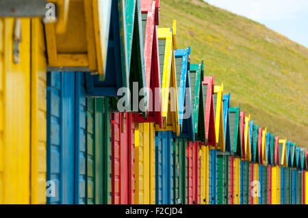 Multi-coloured beach huts at Whitby Beach, Whitby, Yorkshire, England, UK Stock Photo