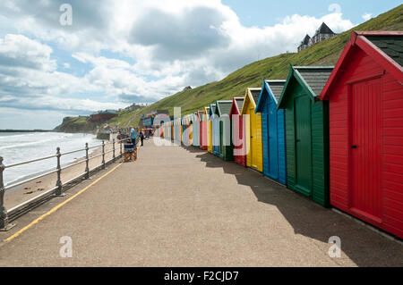 Multi-coloured beach huts at Whitby Beach, Whitby, Yorkshire, England, UK Stock Photo