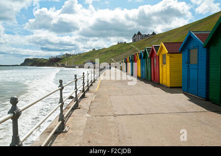 Multi-coloured beach huts at Whitby Beach, Whitby, Yorkshire, England, UK Stock Photo